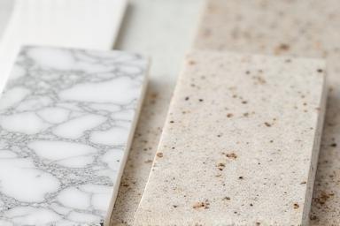 Close-up examples showcasing textures of different kitchen countertop materials like marble, granite, and quartz.
